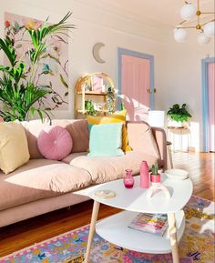 a living room filled with furniture and lots of plants