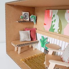 a doll house with furniture and accessories on the shelves, including a table and chair