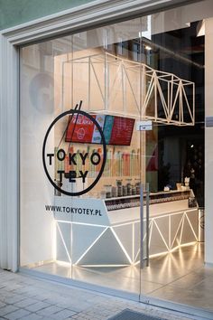 a store front window with the tokyo logo on it's glass display case,