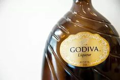 a bottle of liquid that is brown with gold trimmings and the word godiva on it