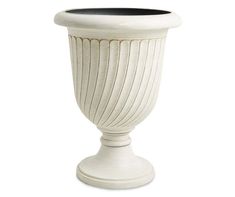 a white vase sitting on top of a table