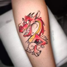 a dragon tattoo on the arm with an orange and yellow ribbon around it's neck