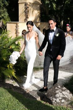 a bride and groom walking down the aisle