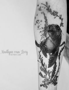 a black and white photo of a sea lion tattoo