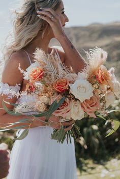 a woman holding a bouquet of flowers in her hands