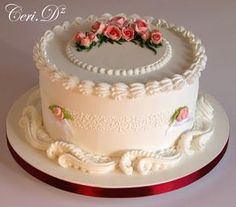 a white cake with pink flowers on top