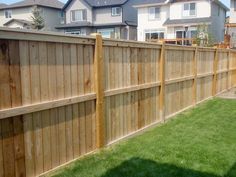 a wooden fence in front of some houses