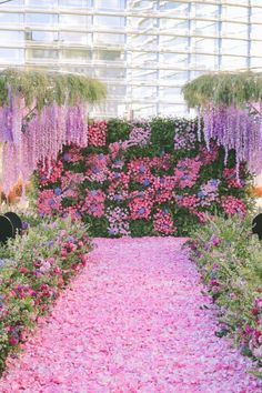 the walkway is covered with pink and purple flowers