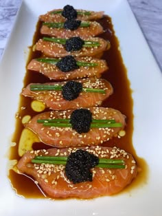 a white plate topped with salmon covered in sauce