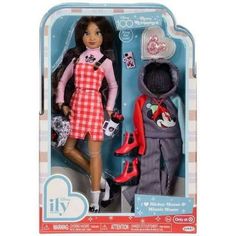 two dolls are in the packaging for their new dollhouse collection, one is wearing an apron and overalls while the other is holding a purse