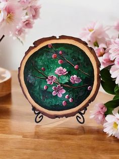 a wooden slice with flowers painted on it