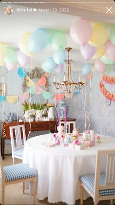 a party with balloons and cake on the table