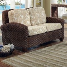 a living room scene with focus on the couch and rug in front of the window