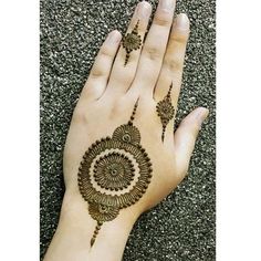 a woman's hand with hennap on it, and an intricate design