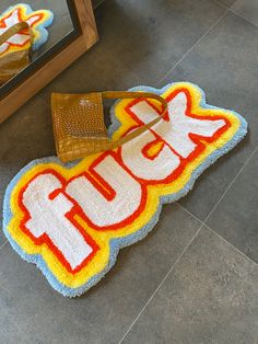 a rug that says laugh on the floor next to a mirror