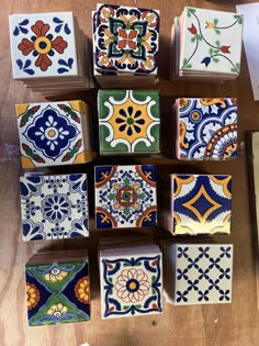 many colorful tiles are arranged on a table