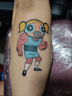 a person with a cartoon tattoo on their leg