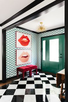 a black and white checkered floor with two paintings on the wall, one has red lips