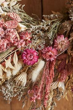 dried flowers and grasses on a wooden surface