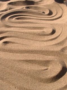 the sand has swirls in it as if they were made out of water or sand