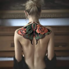 the back of a woman's body with tattoos on her upper and lower half