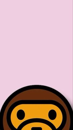 a brown and black monkey face on a pink background