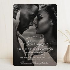 a black and white photo of two people in front of a wedding card with the words,