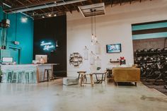 a room filled with furniture and decor in front of a wall mounted screen tv on the wall