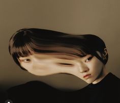 a woman with her hair blowing in the wind while she is wearing a black shirt