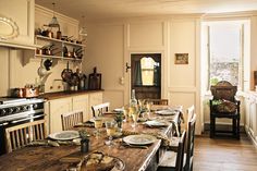 a dining room table with plates and glasses on it