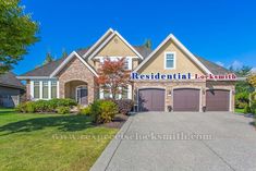 a large house with two garages in front of it and the words residential locksmith on