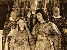 an old black and white photo of people dressed in medieval costumes, standing next to each other