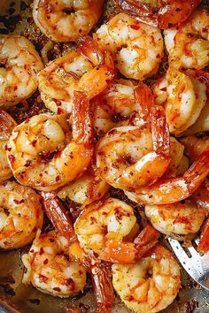 the cooked shrimp is ready to be served in the skillet with sauce and seasoning