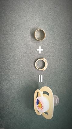 a pacifier, ring and other items are arranged on the floor next to each other