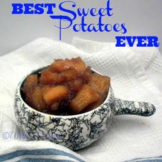 a small bowl filled with sweet potatoes on top of a white and blue towel next to a spoon