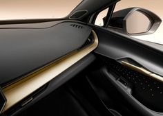 the interior of a car with black leather and gold trim