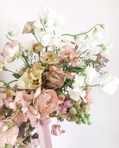 a vase filled with lots of flowers on top of a table