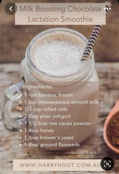 a glass jar filled with chocolate latte on top of a wooden table next to a spoon