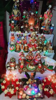 a table topped with lots of different types of decorations and lights on top of it