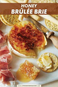 honey brulee brie on a plate with crackers and other food items