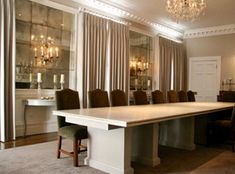 a dining room table with chairs and chandelier