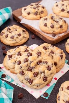 chocolate chip cookies are on top of napkins