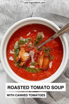 roasted tomato soup with canned tomatoes and parmesan cheese in a white bowl on a striped towel