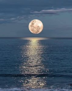 the full moon shines brightly in the sky over the ocean as it reflects on the water