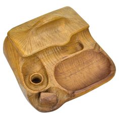 a wooden object that is shaped like an elephant's head and has two holes in it