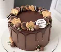 a chocolate cake with cookies and crackers on top