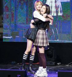 two girls hugging each other on stage