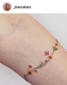 a woman's arm with flowers on it and the words bancakto written in