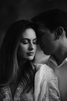 black and white photograph of a man kissing a woman's head with her eyes closed