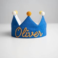 a blue crown with the word ollier written on it